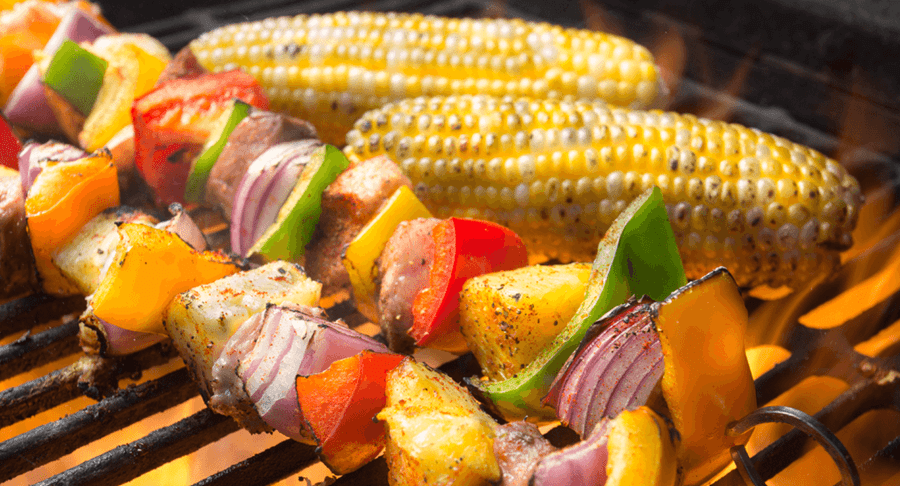 Vegetable and meat skewers cooking on the barbecue