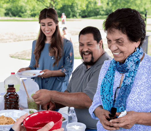 Group of people having a potluck outside