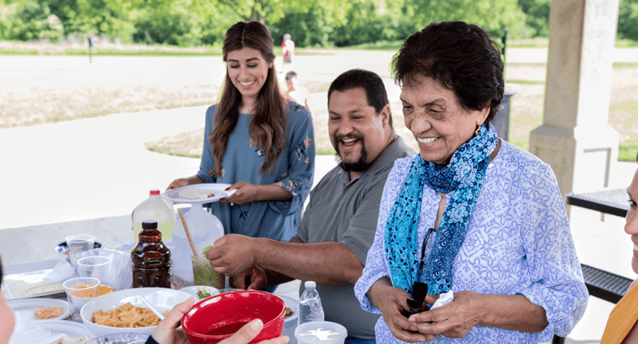 Group of people having a potluck outside