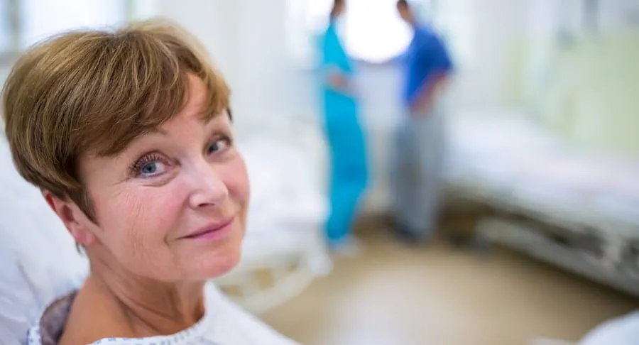 Patient in a hospital bed wearing a gown