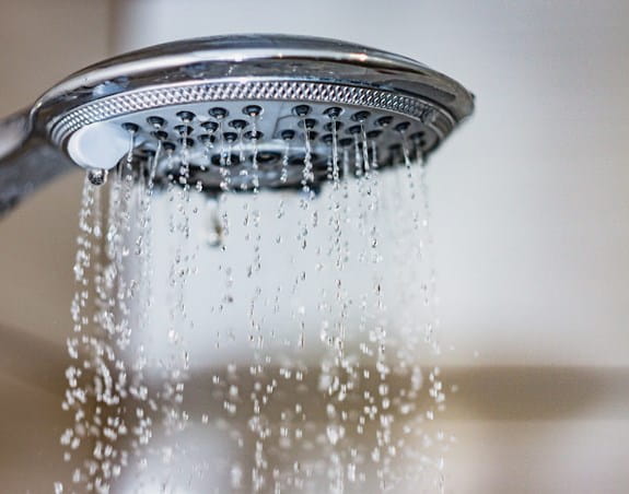 Shower head with water streaming from it 