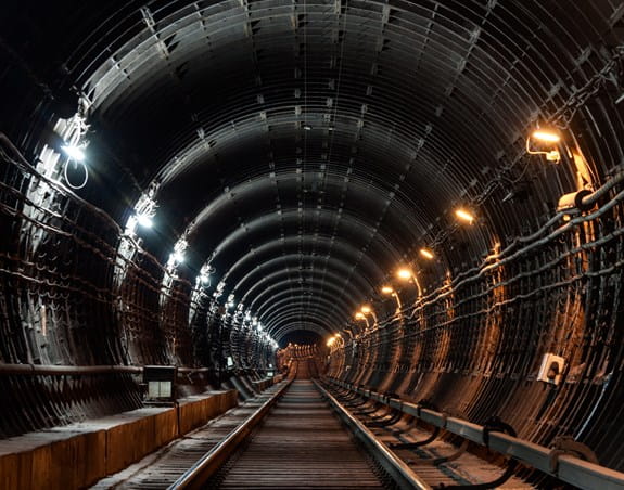 Underground subway tunnel with lights illuminating it