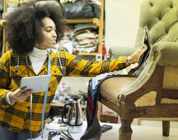 Person upholstering a chair