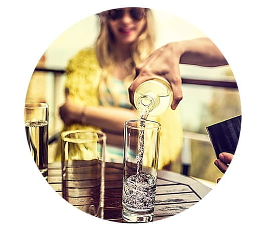 Person pouring water into a glass