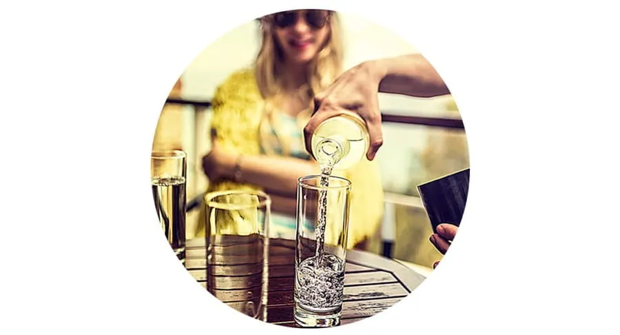 Person pouring water into a glass