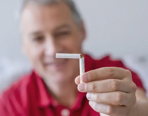 Person holding a broken cigarette