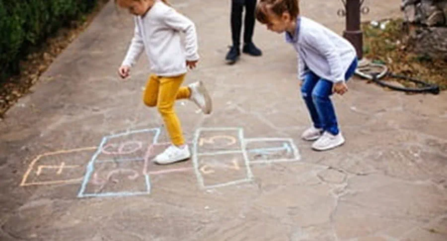 Two children playing hopscotch