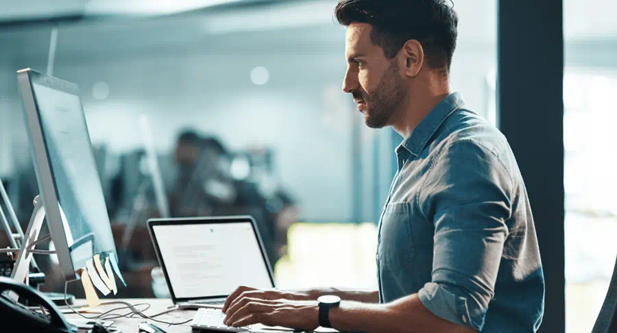 Person typing on a computer at a desk in an office