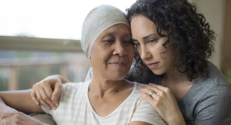 A cancer patient being embraced by another person