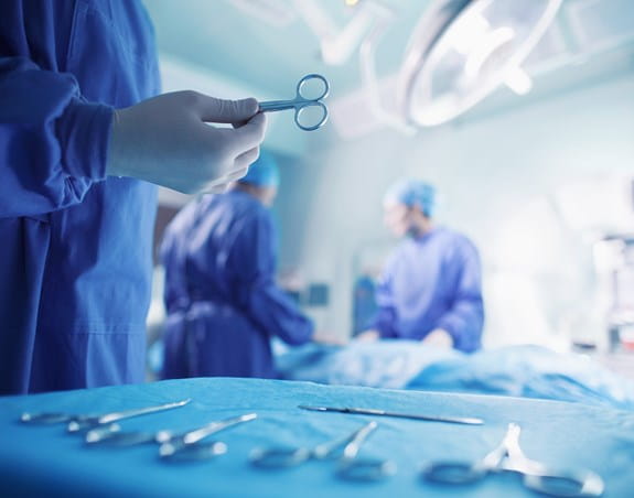 Doctors performing surgery in a hospital operating room