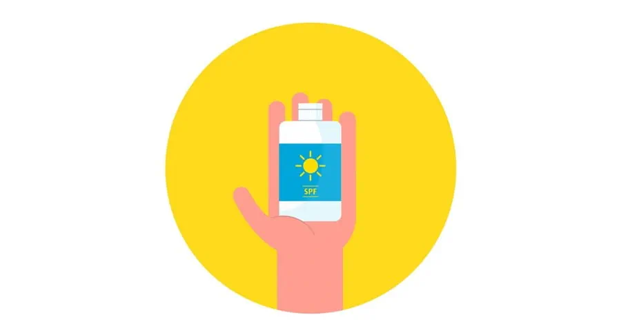 Bottle of sunscreen in someone’s hand