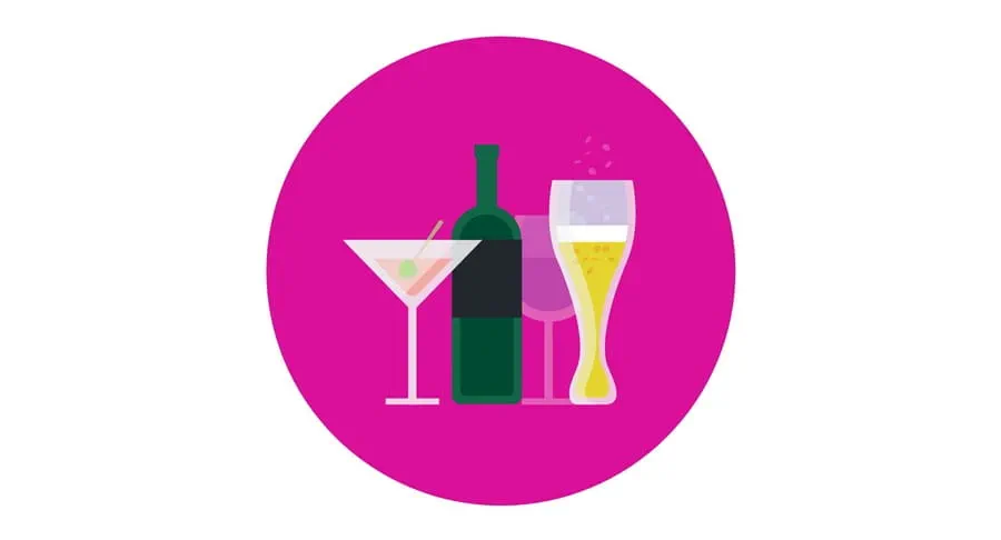 A wine bottle and glasses of different types of alcohol