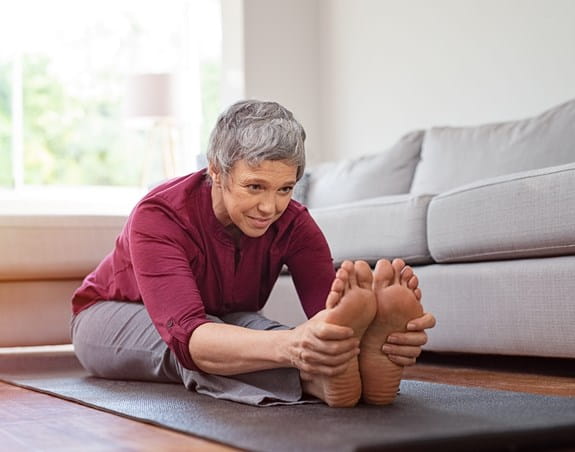 Person stretching on a yoga mat