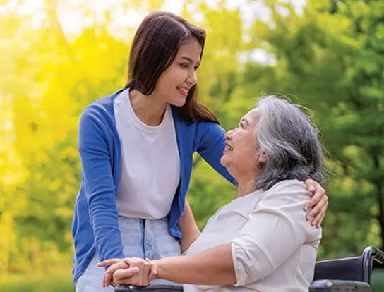 Image of a young woman embracing her grandmother