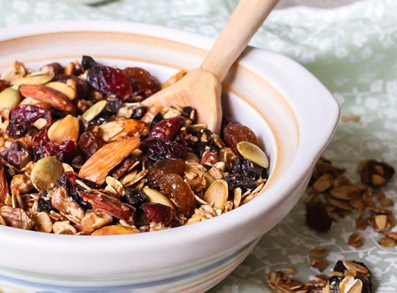 A bowl of granola with fruit and nuts