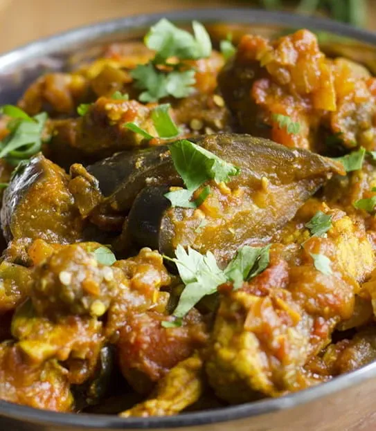 A bowl of Roasted eggplant curry with coconut sambol