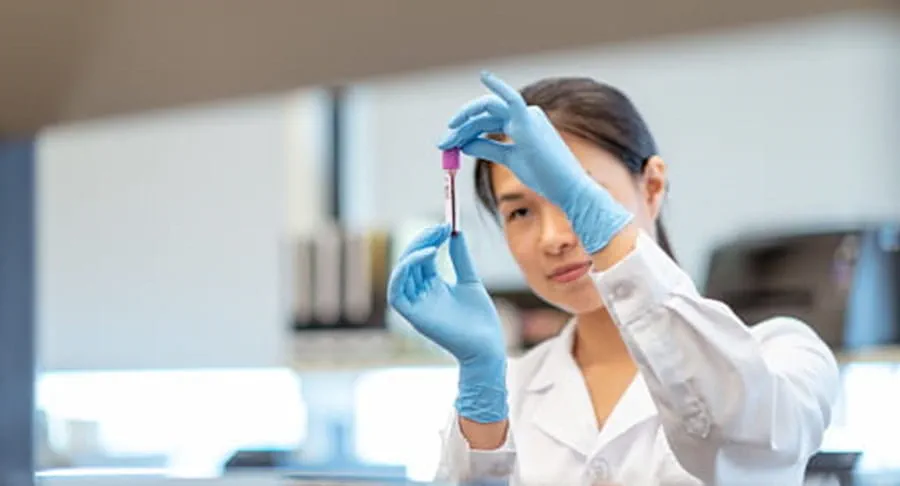 Women holding up a test tube.