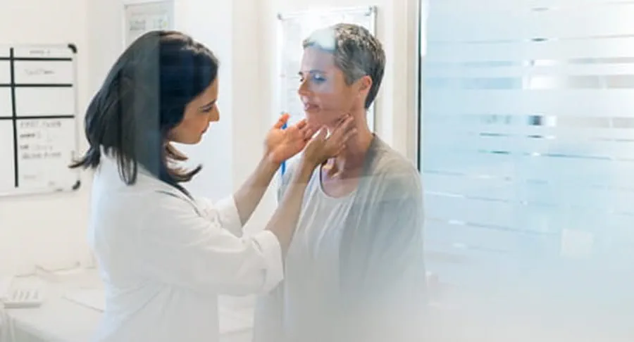 Doctor checking a patients lymph nodes and neck.