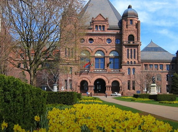 Parliament Building of the Province of Ontario, with spring daffodils blooming in it's garden, known as Queen's Park