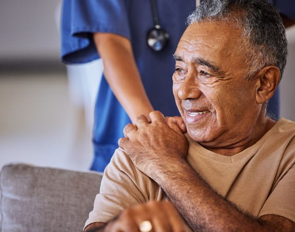 A man holding the hand of a doctor