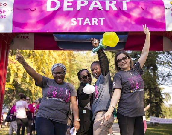 Four women celebrating at the Run for the Cure start line