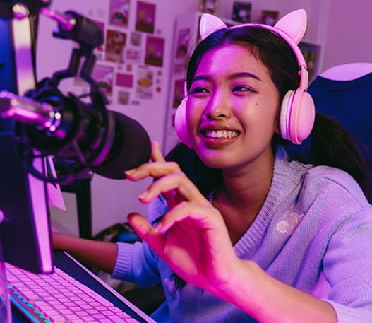 A woman in cat ear headphones streaming a video game 