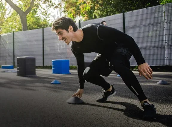 Person crouched during outdoor agility training