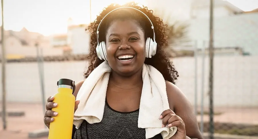 Person after run holding water bottle