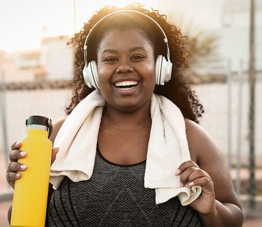 Person after run holding water bottle