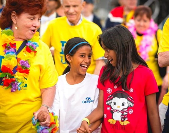 Two young girls walk with their mom at Relay For Life.