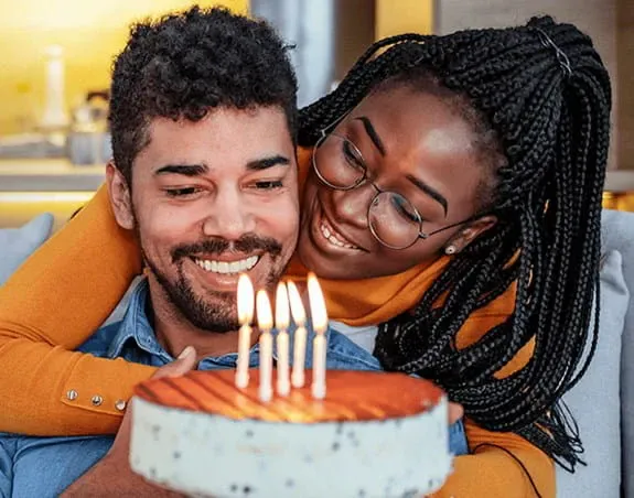 A man and a woman with a birthday cake