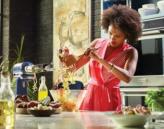 A person transferring food from one bowl to another