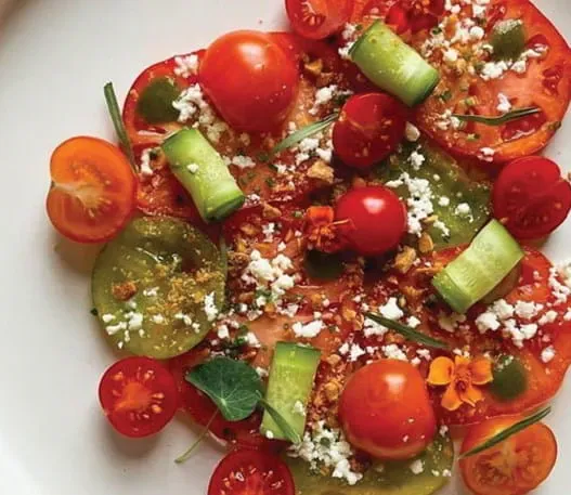 Tomato salad with cucumbers, toasted almonds, lemon ricotta and chermoula