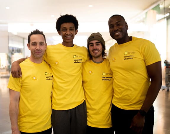A group of cancer society volunteers wearing yellow t-shirts
