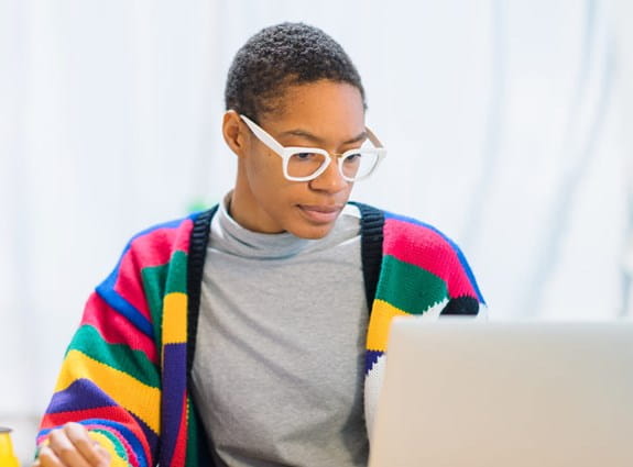 A woman sitting at her laptop computer