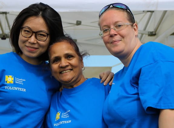 Three women volunteers hugging