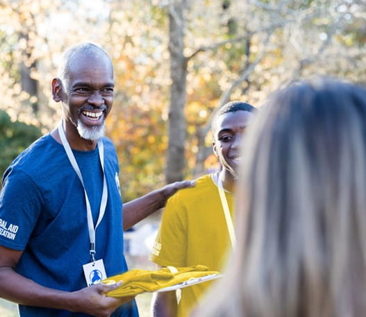 A male volunteer talking to a group of volunteers