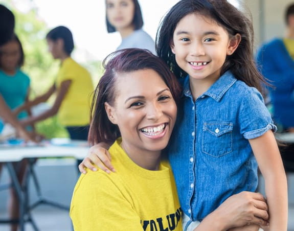 woman and a child hugging outside