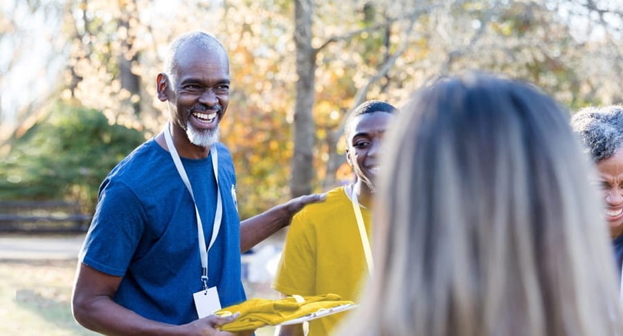 A male volunteer talking to a group of volunteers