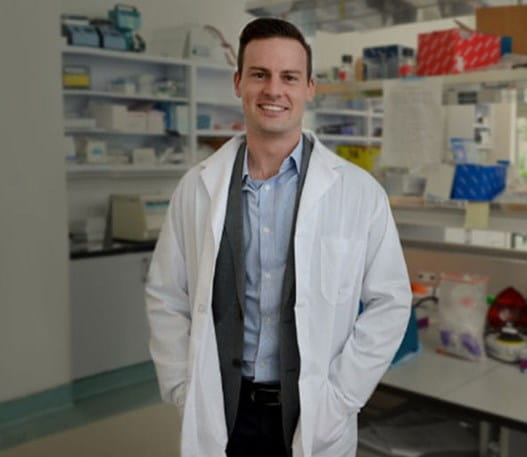 Dr Alexander Wyatt standing in a pharmacy