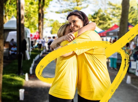 Two women hugging at Relay