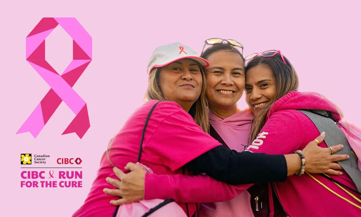 Three women leaning against one another and smiling.