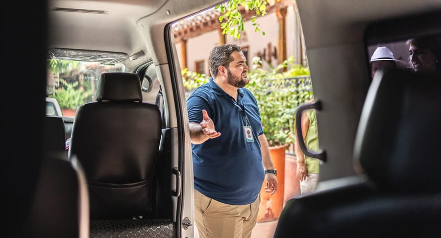 A man opening a van door