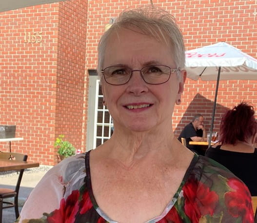 Photo of a woman sitting on a restaurant patio