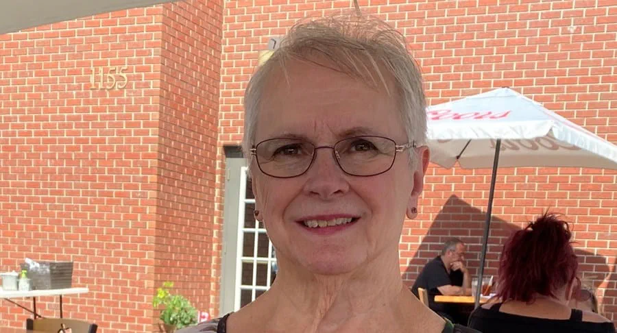 Photo of a woman sitting on a restaurant patio
