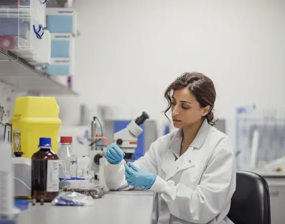 A female researcher conducting experiment at a lab.