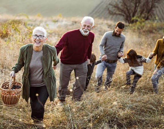 A family holding hands and walking together.