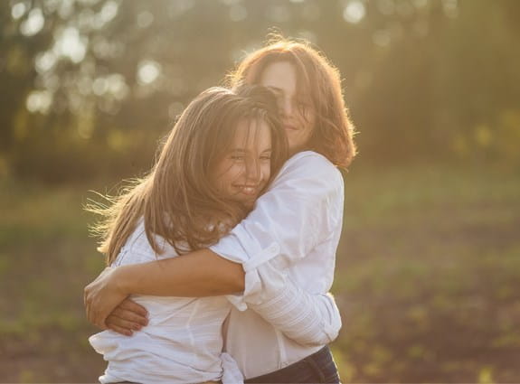 Mom and daughter hugging
