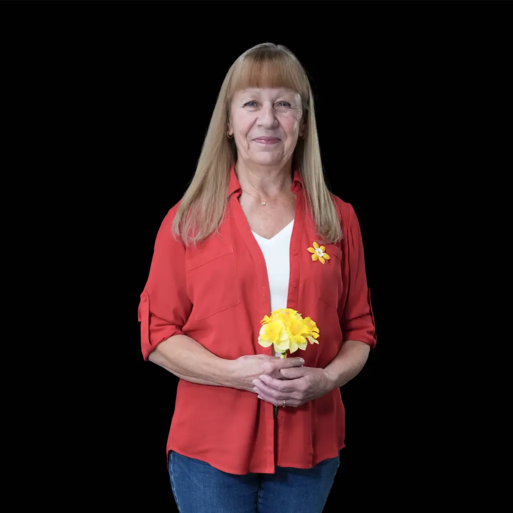 Cancer survivor, Cassidy London, alongside her husband and two children. Cassidy is holding a daffodil, symbolizing hope.