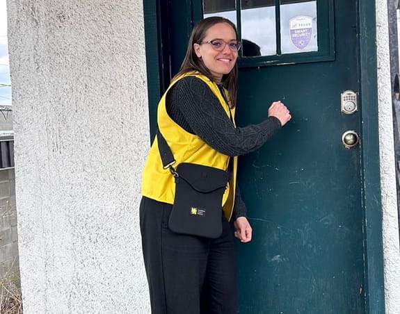 a ccs canvasser knocking on a door